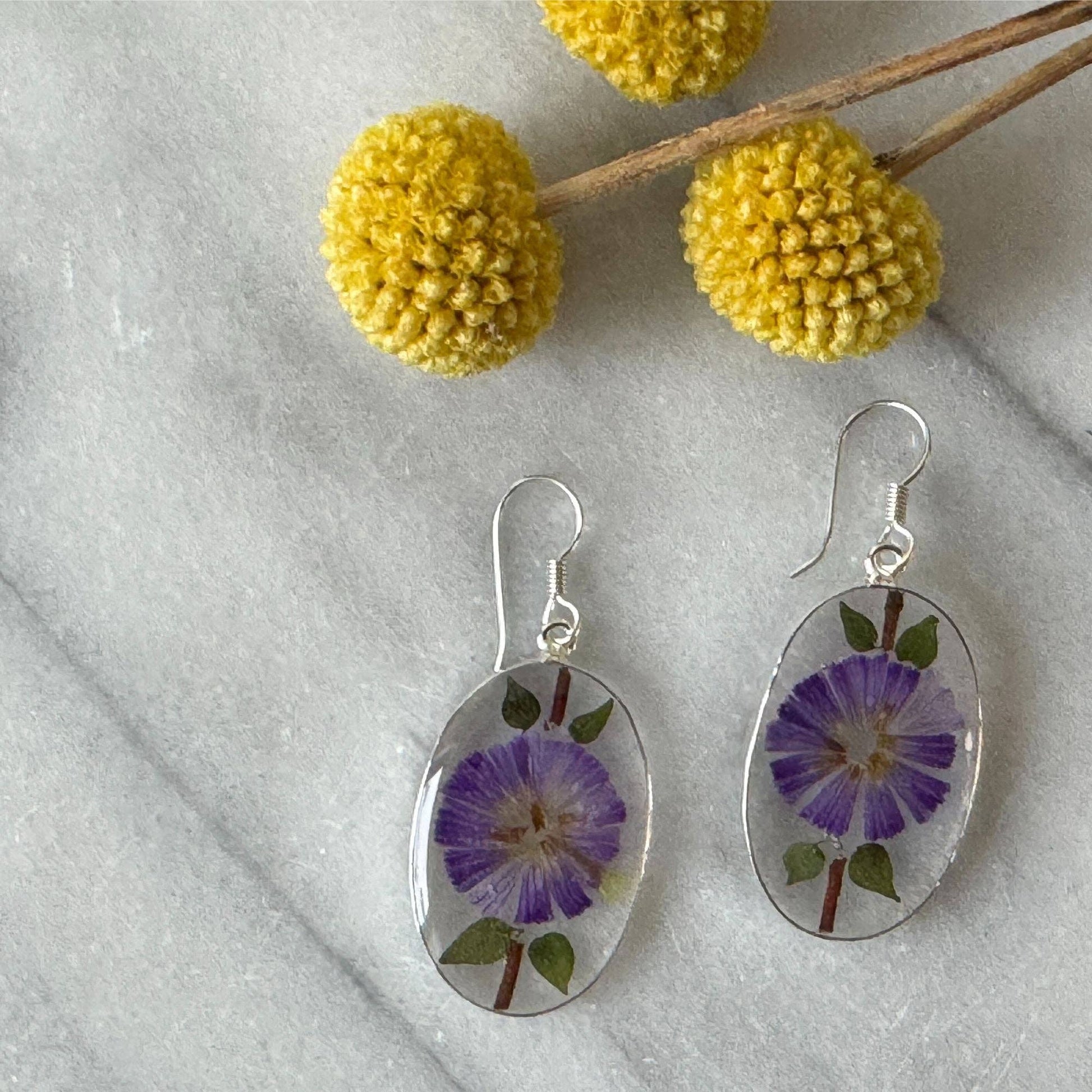 Alpaca Silver Oval with Purple Pressed Flower Dangle Earrings - Recetas Fair Trade